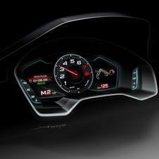 The instrument panel has a central tachometer and two LCD screens