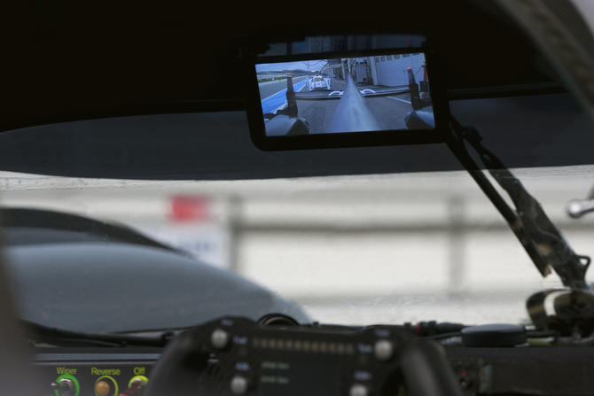 The screen is mounted in the same location as a normal rear-view mirror The screen is mounted in the same location as a normal rear-view mirror