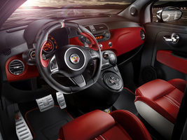 The interior is covered in red leather with white accents and red stitching