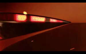 The car is being shown in a fiery orange
